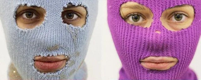 Two Pussy Riot members in pale blue and purple knitted balaclavas.