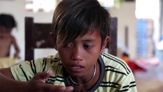 Vergel looks down while speaking in the Typhoon Haiyan film.